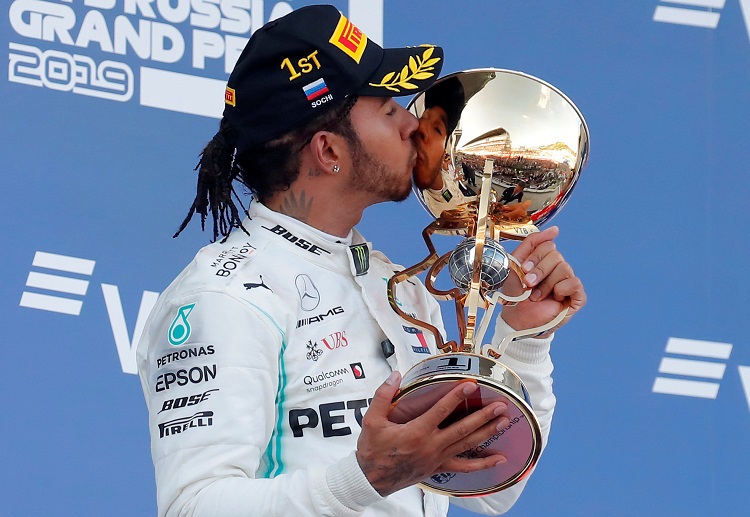 Lewis Hamilton stands in the top podium after driving his way to victory in the Russian Grand Prix